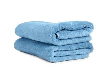 Photo of Folded soft terry towels on white background