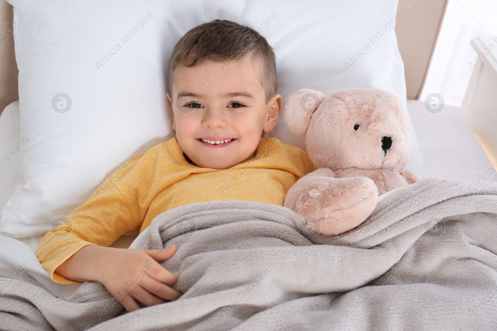 Photo of Cute child resting in bed at hospital