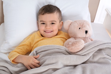 Photo of Cute child resting in bed at hospital