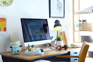 Photo of Comfortable designer's workplace with modern computer in studio