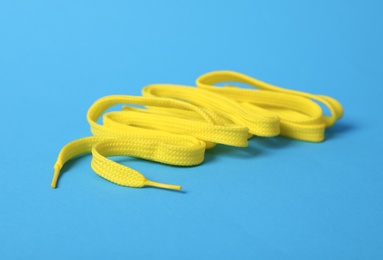 Yellow shoe lace on light blue background