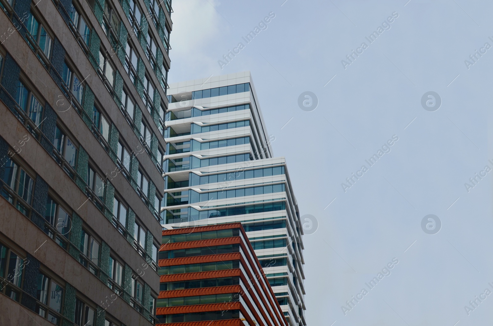 Photo of Exterior of beautiful modern skyscrapers against blue sky