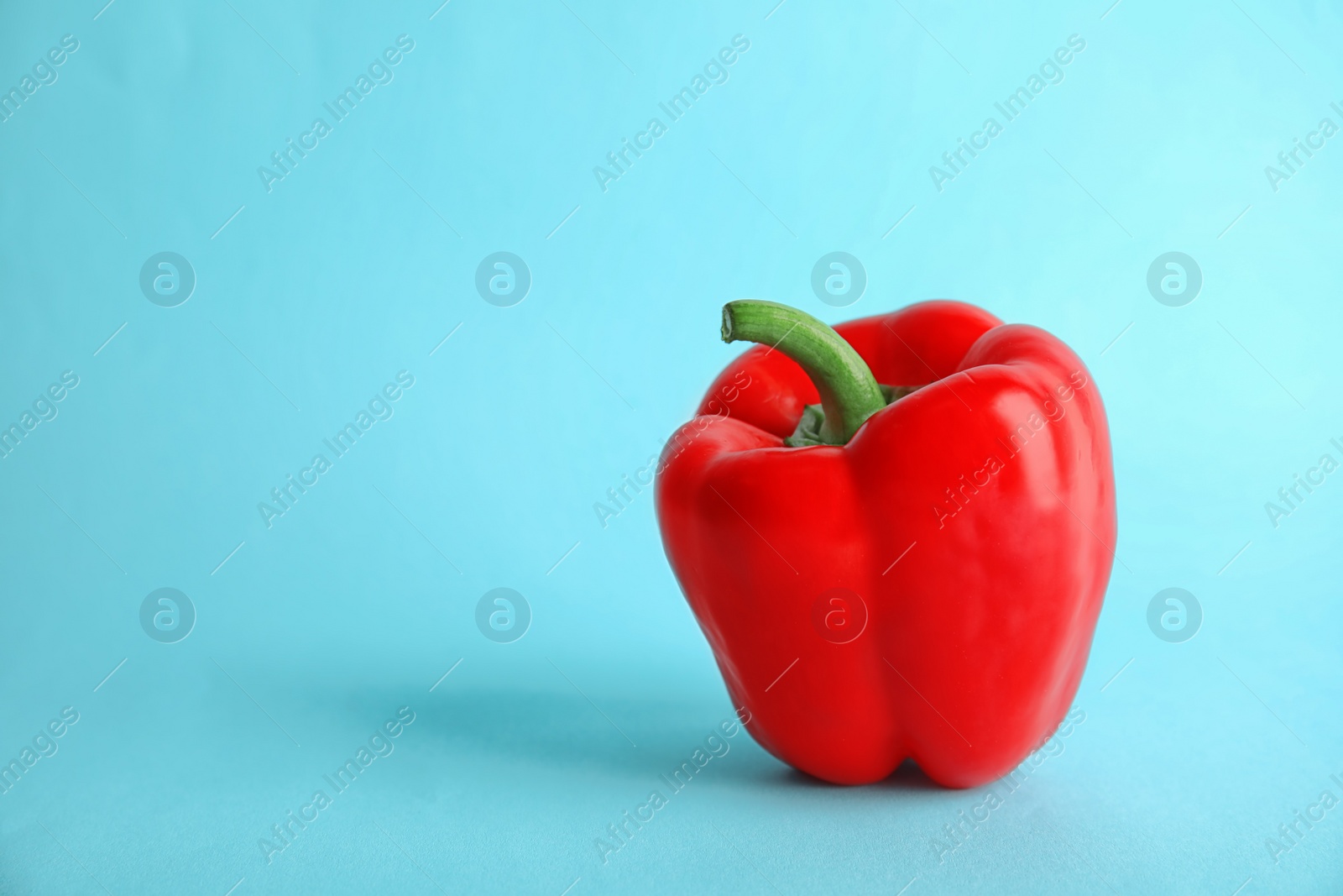 Photo of Raw ripe paprika pepper on color background