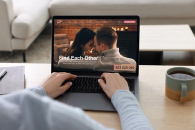 Looking for partner. Woman using laptop at table, closeup. Dating site webpage on device screen