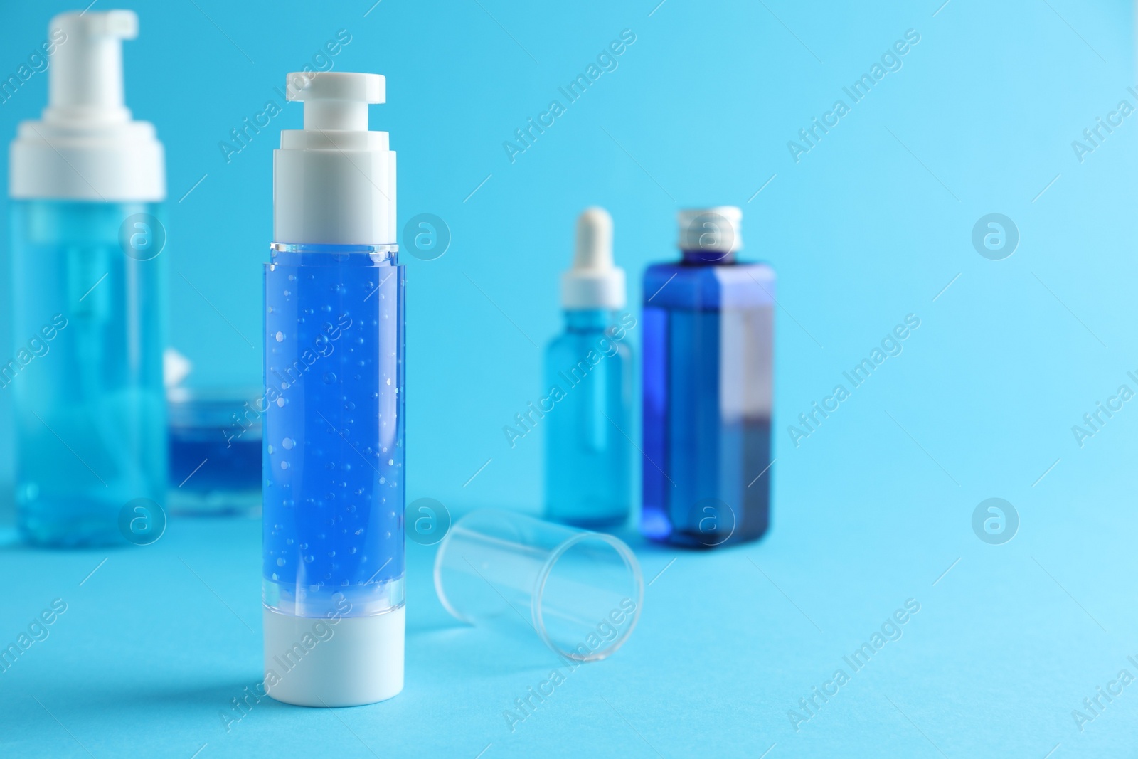 Photo of Different cosmetic products on light blue background. Space for text