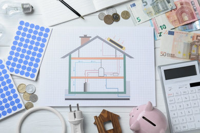 Photo of Flat lay composition with solar panels and house project on white wooden table