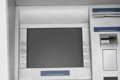 Photo of Modern automated cash machine with screen outdoors, closeup