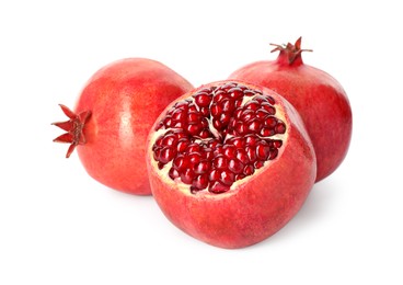 Photo of Many fresh ripe pomegranates isolated on white