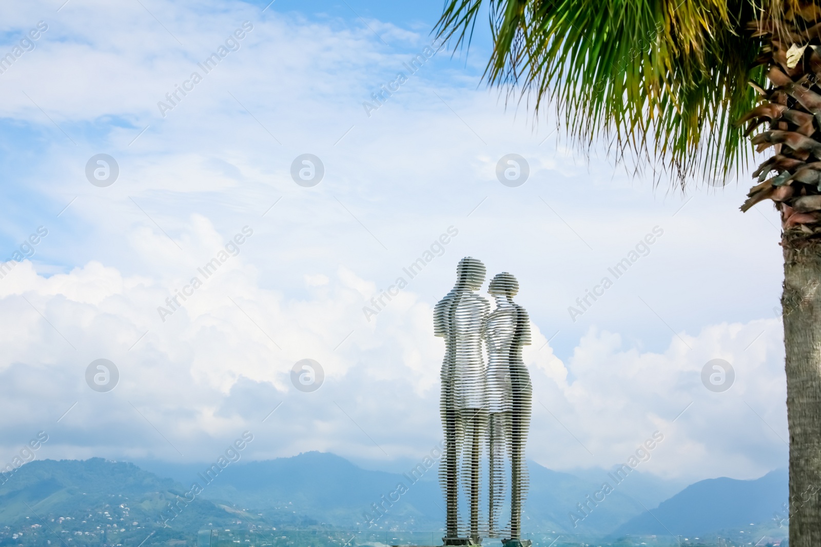 Photo of BATUMI, GEORGIA - JUNE 14, 2022: Movable sculptural composition Ali and Nino with breathtaking landscape on background