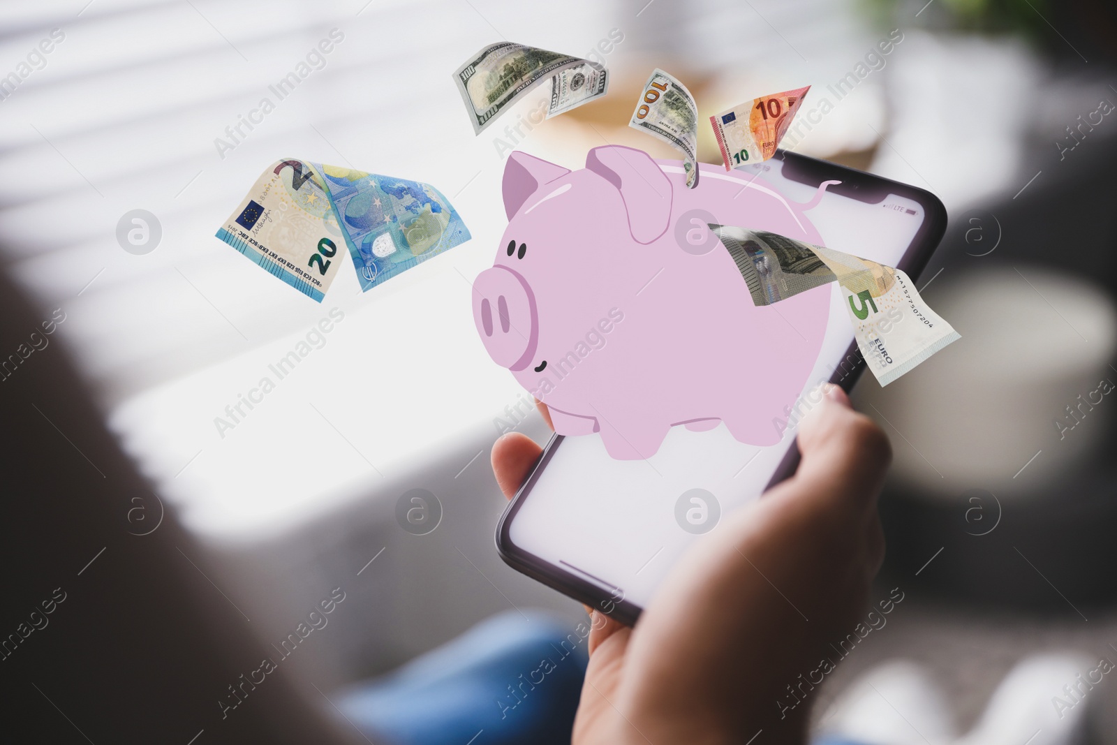 Image of Man using online bank application on his smartphone indoors