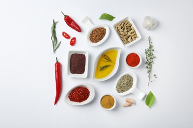 Composition with different aromatic spices on white background, top view