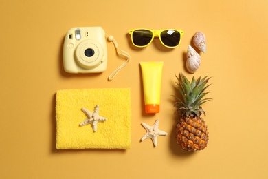 Flat lay composition with beach accessories on color background