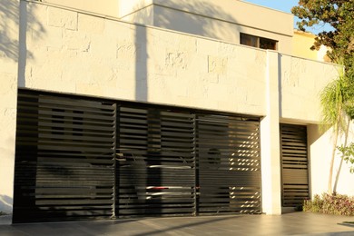 Photo of Closed gates of modern garage. Exterior design