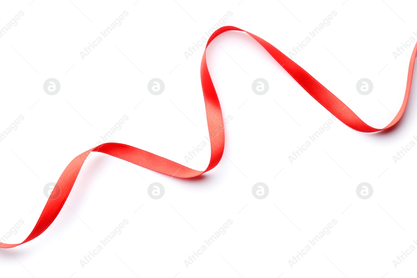 Photo of Simple red ribbon on white background, top view. Festive decoration