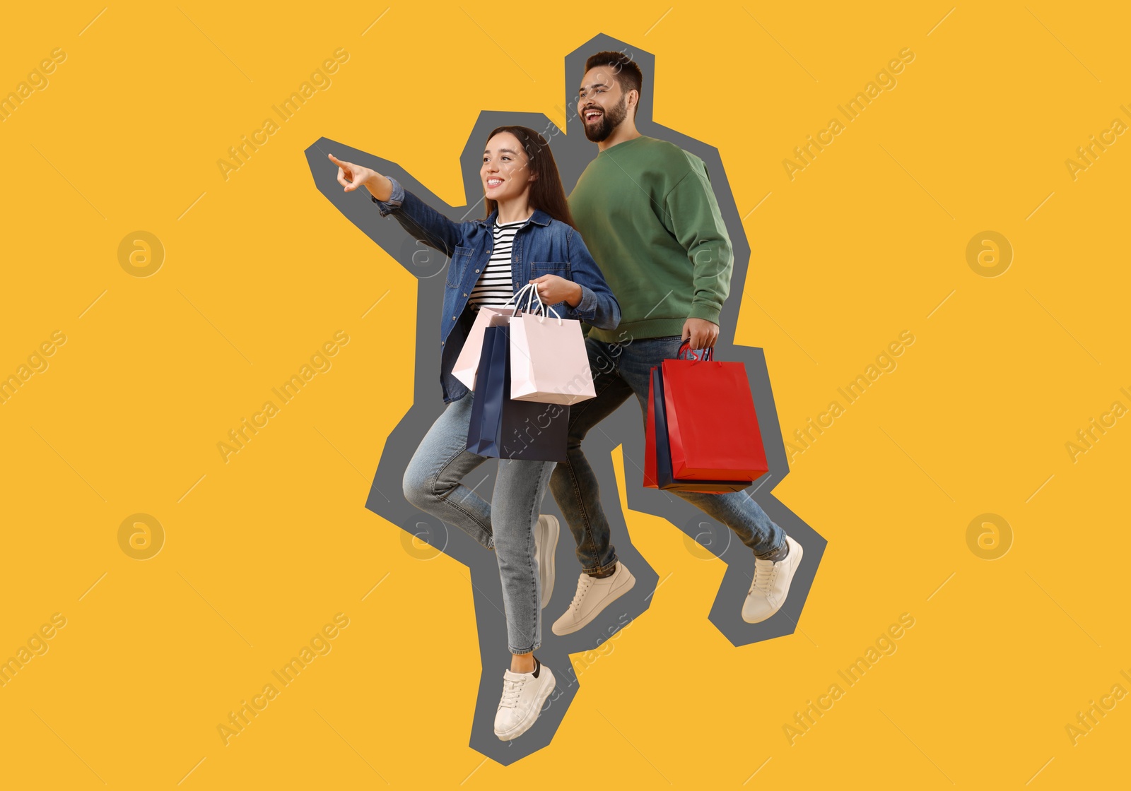 Image of Happy couple with shopping bags jumping on orange background