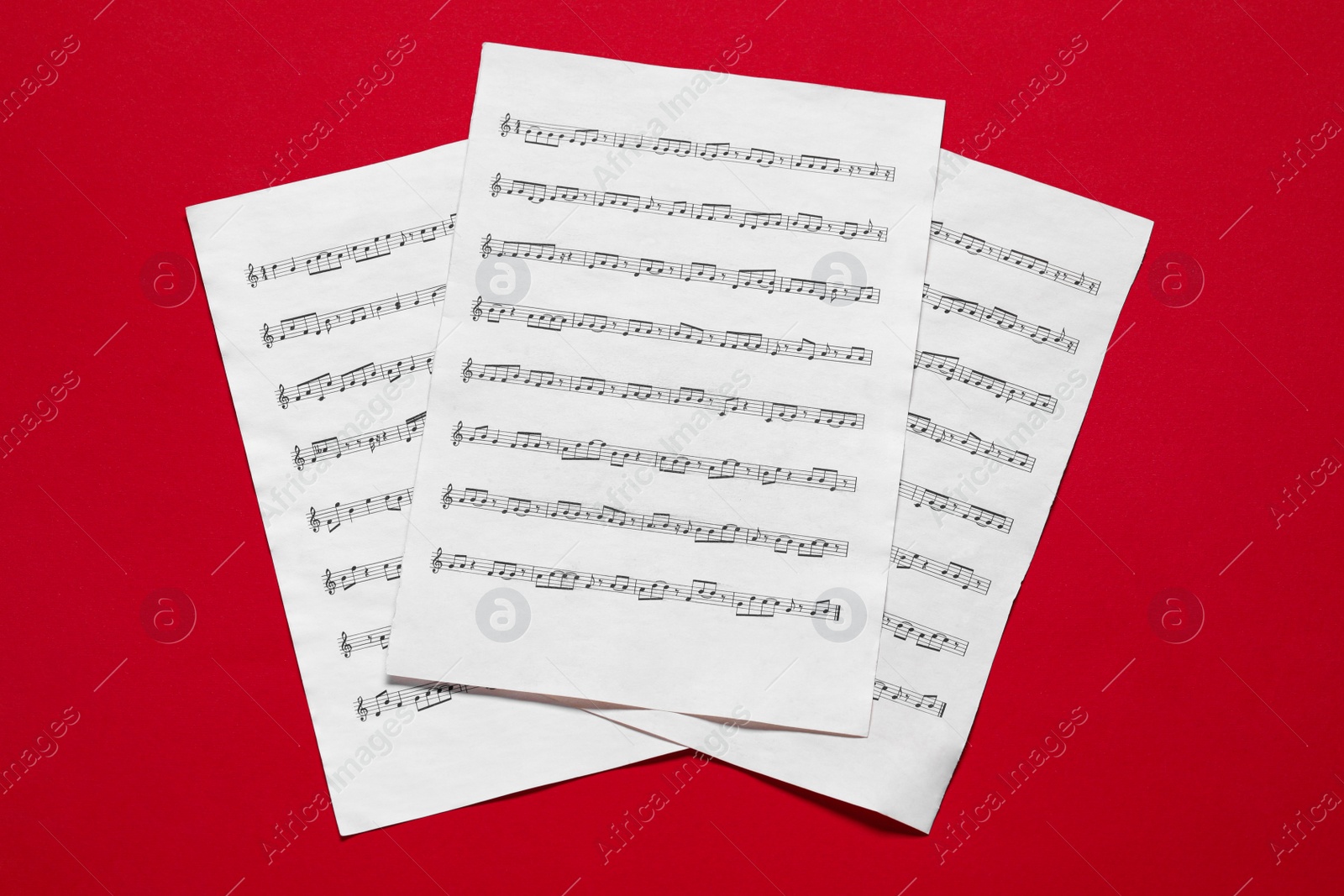 Photo of Note sheets on red background, flat lay
