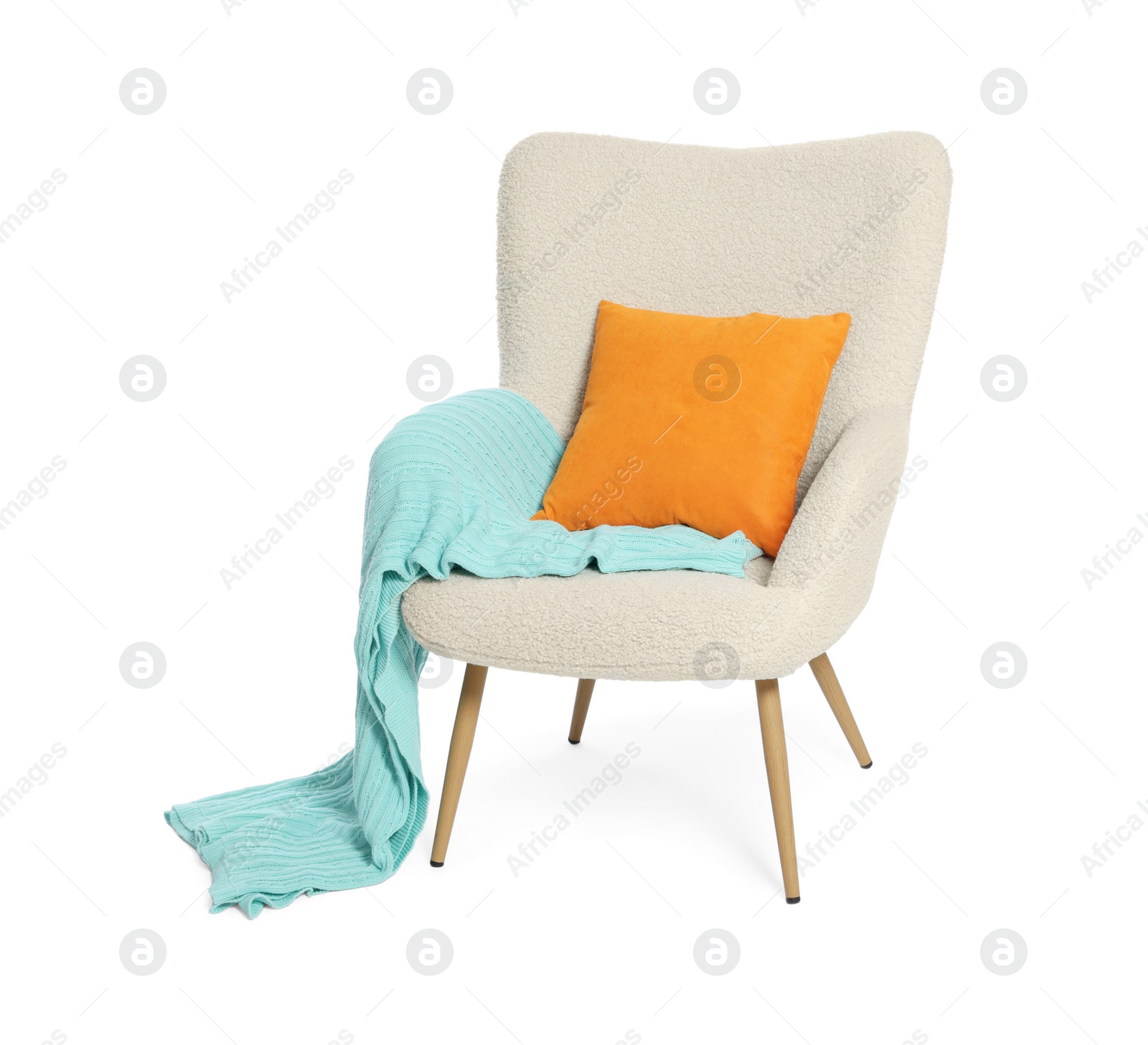 Photo of One stylish comfortable armchair with blanket and pillow isolated on white