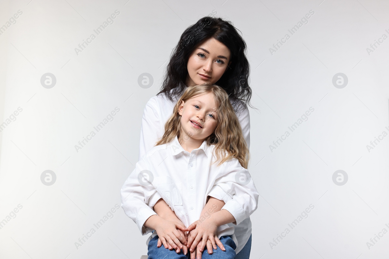 Photo of Beautiful mother with little daughter on white background