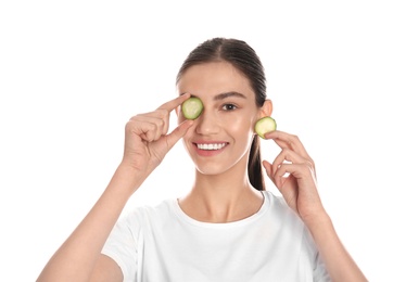 Photo of Happy young woman with cucumber slices on white background. Organic face mask