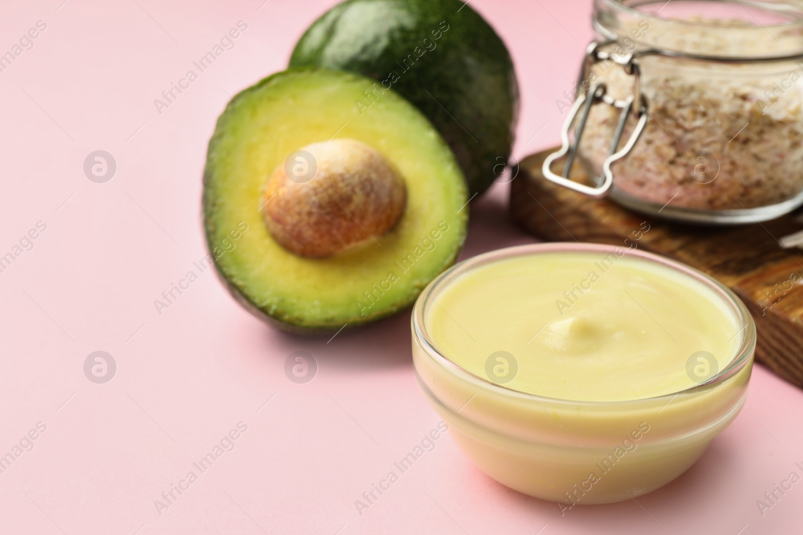 Photo of Handmade face mask in glass bowl and ingredients on pink background