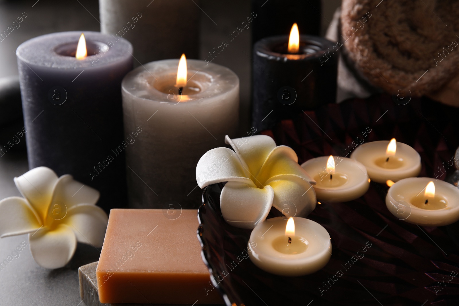 Photo of Spa composition with candles and cosmetic on table