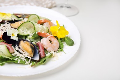 Photo of Platedelicious salad with seafood on white table, space for text