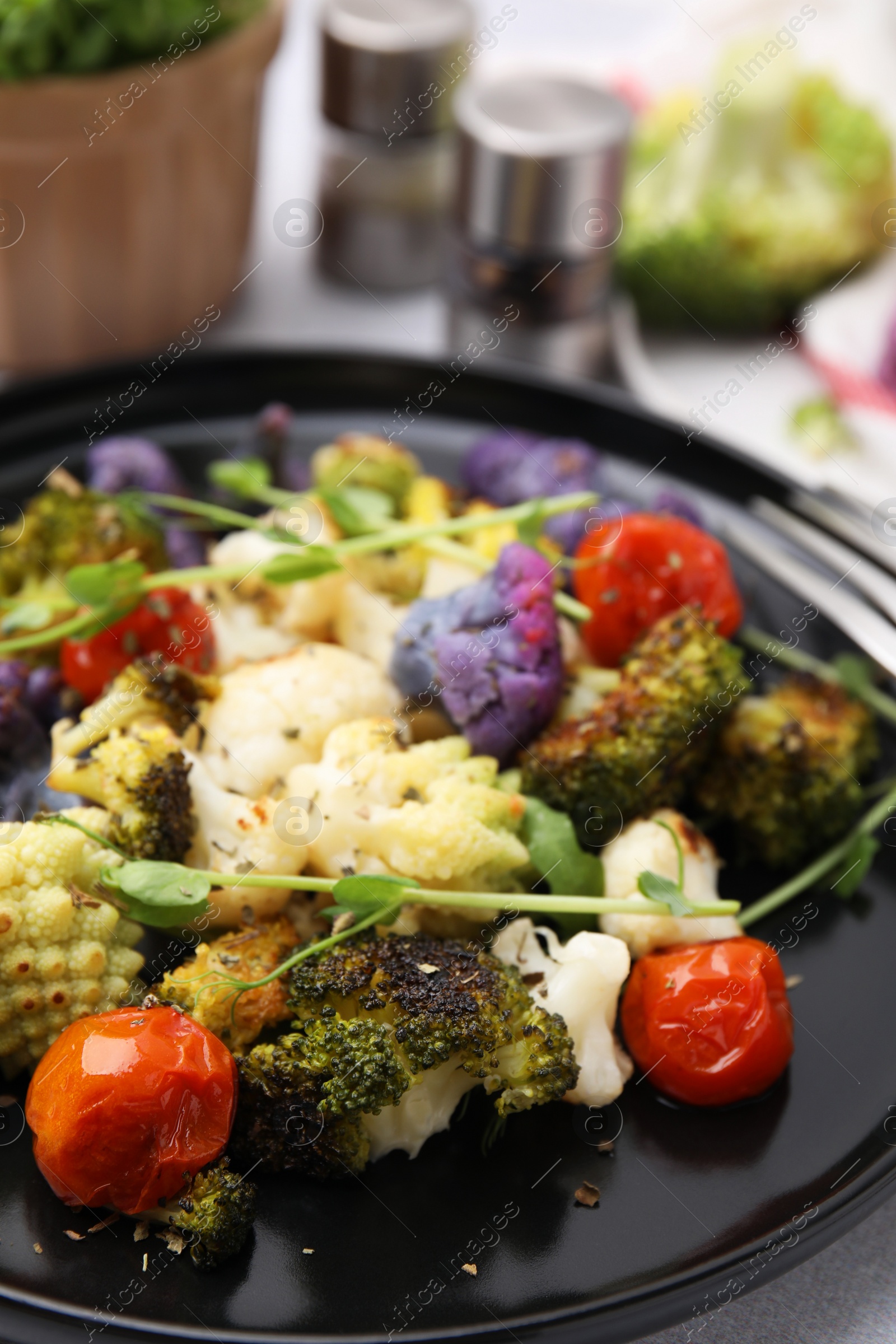 Photo of Delicious salad with cauliflower and tomato on plate, closeup