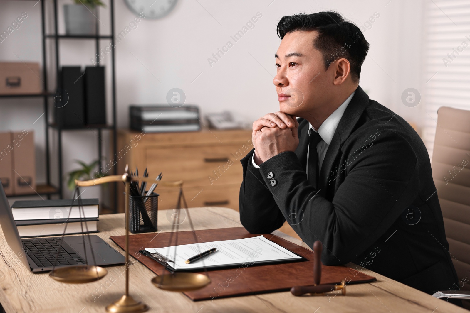 Photo of Notary working at wooden table in office