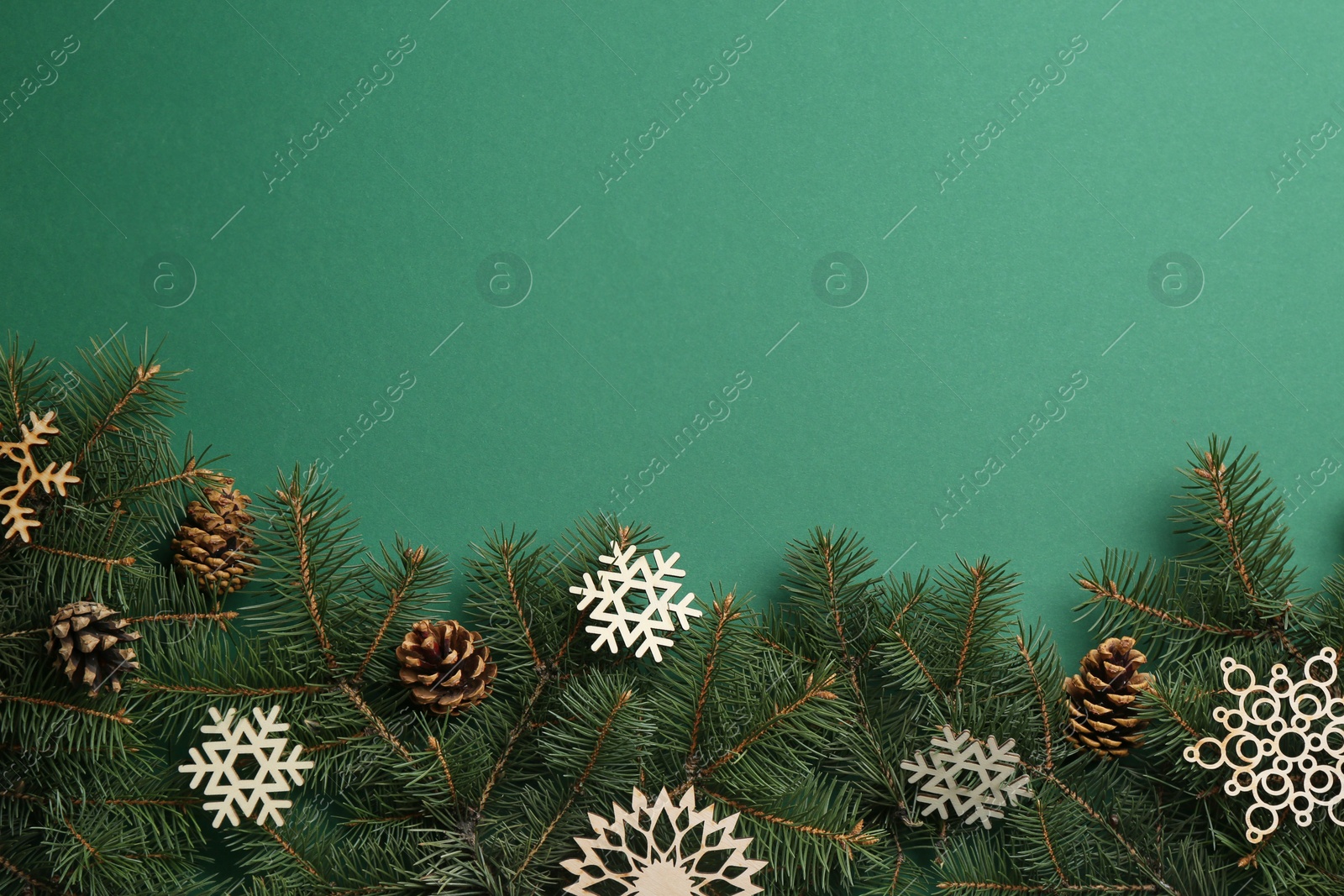Photo of Flat lay composition with Christmas decorations on green background, space for text. Winter season