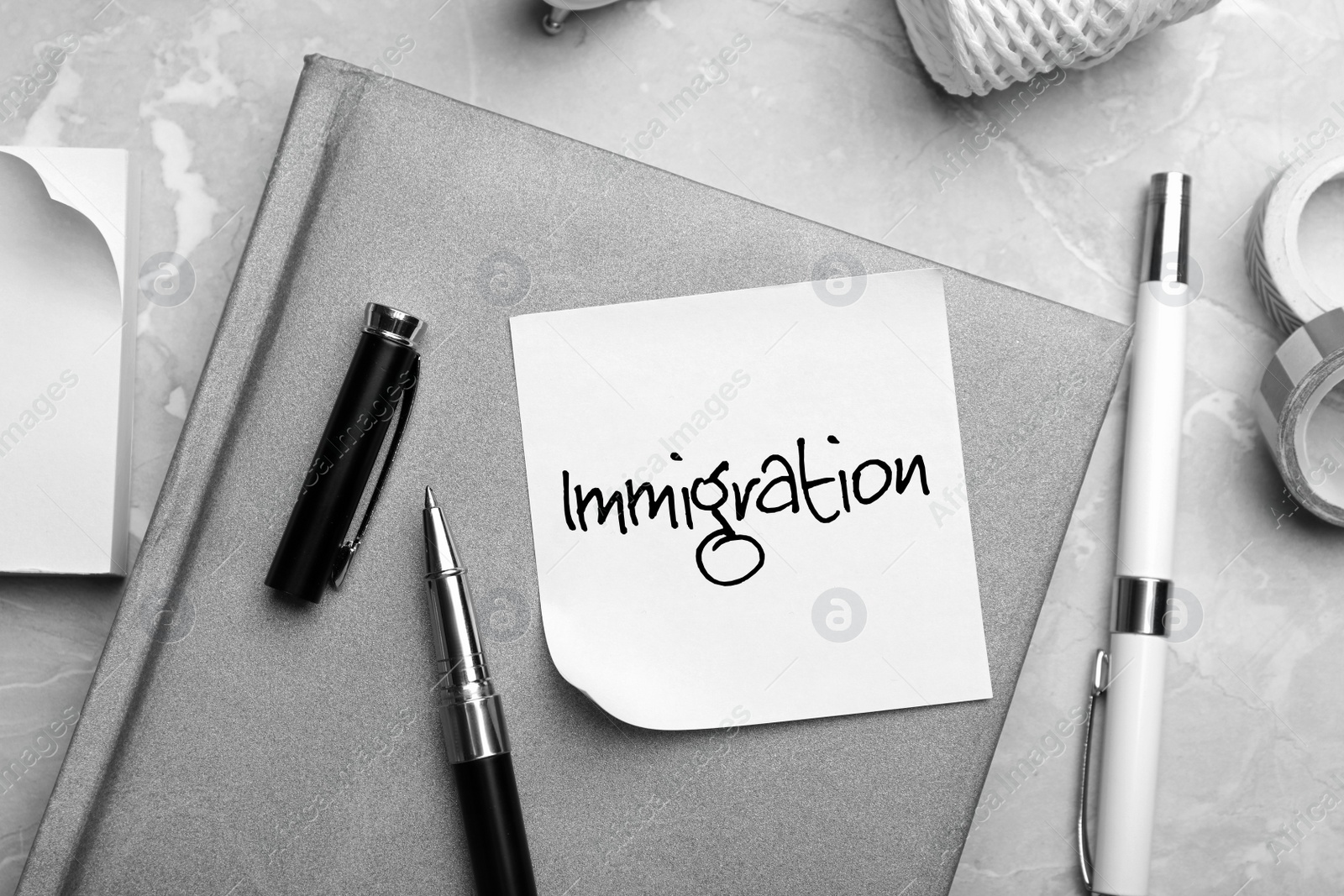 Image of Note with word IMMIGRATION and stationery on grey table, flat lay