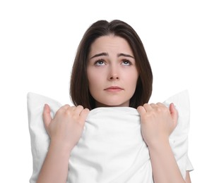 Photo of Unhappy young woman with pillow on white background. Insomnia problem