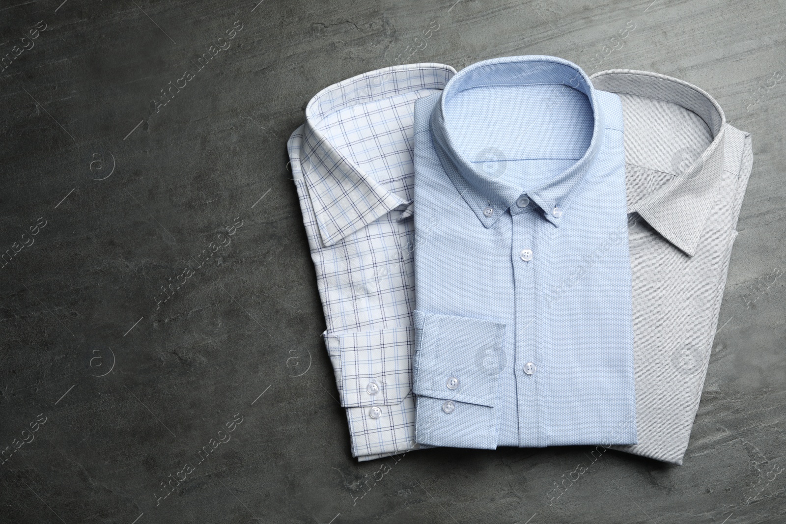 Photo of Stylish male shirts on grey background, flat lay