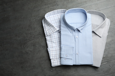 Photo of Stylish male shirts on grey background, flat lay