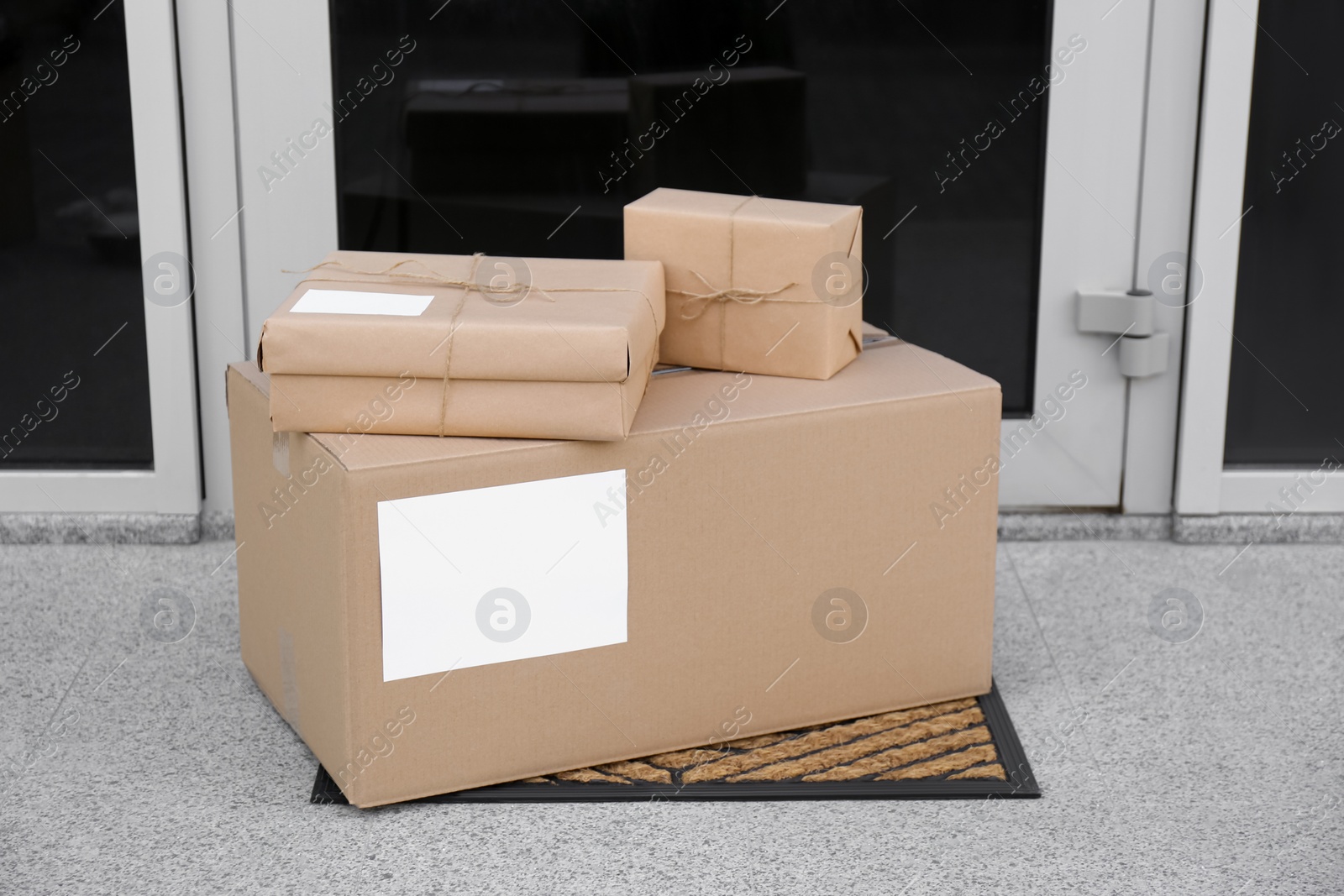 Photo of Delivered parcels on door mat near entrance