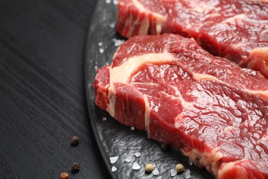 Fresh marbled meat steaks on slate board, closeup