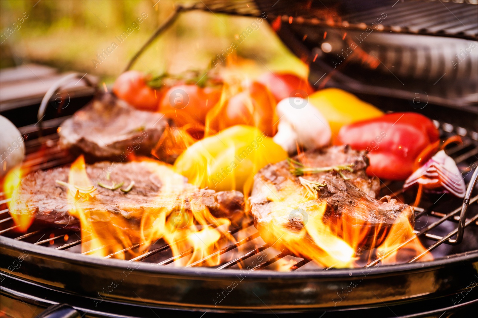 Image of Barbecue grill with food and flame, closeup