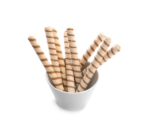 Photo of Bowl with tasty wafer roll sticks on white background. Crispy food