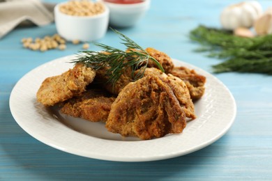 Cooked soy meat on light blue wooden table