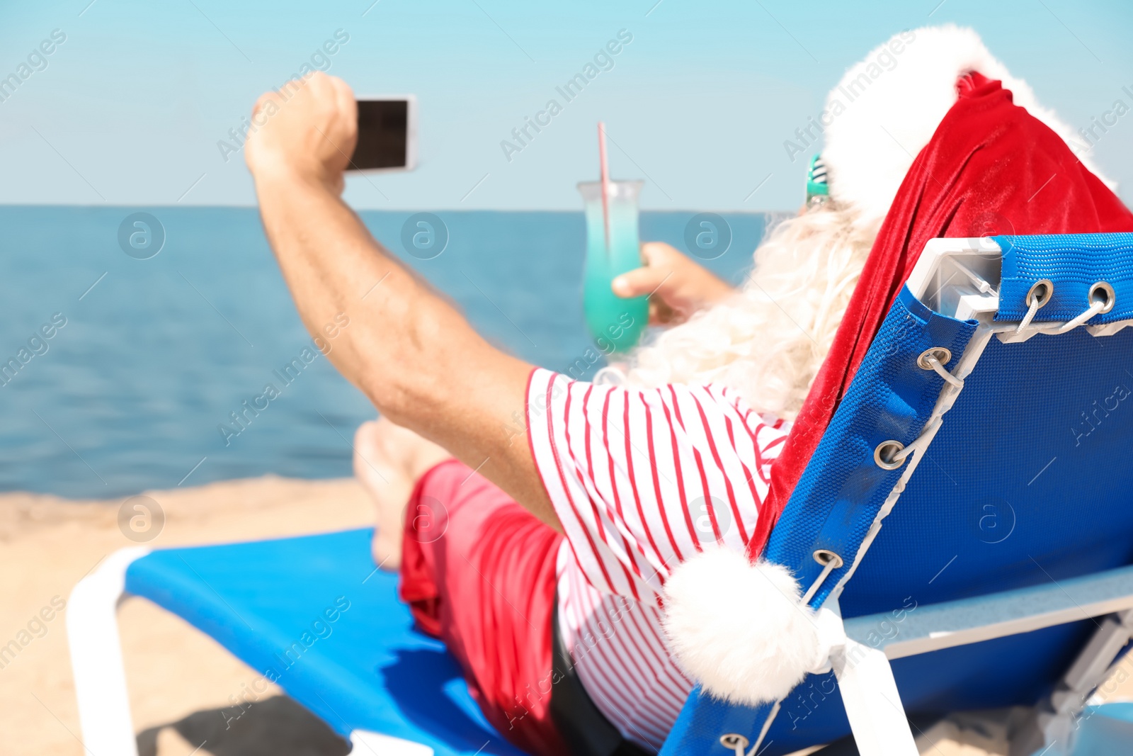 Photo of Authentic Santa Claus taking selfie at resort