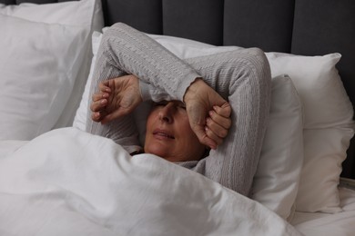 Photo of Menopause, sleep problems. Woman suffering from insomnia in bed