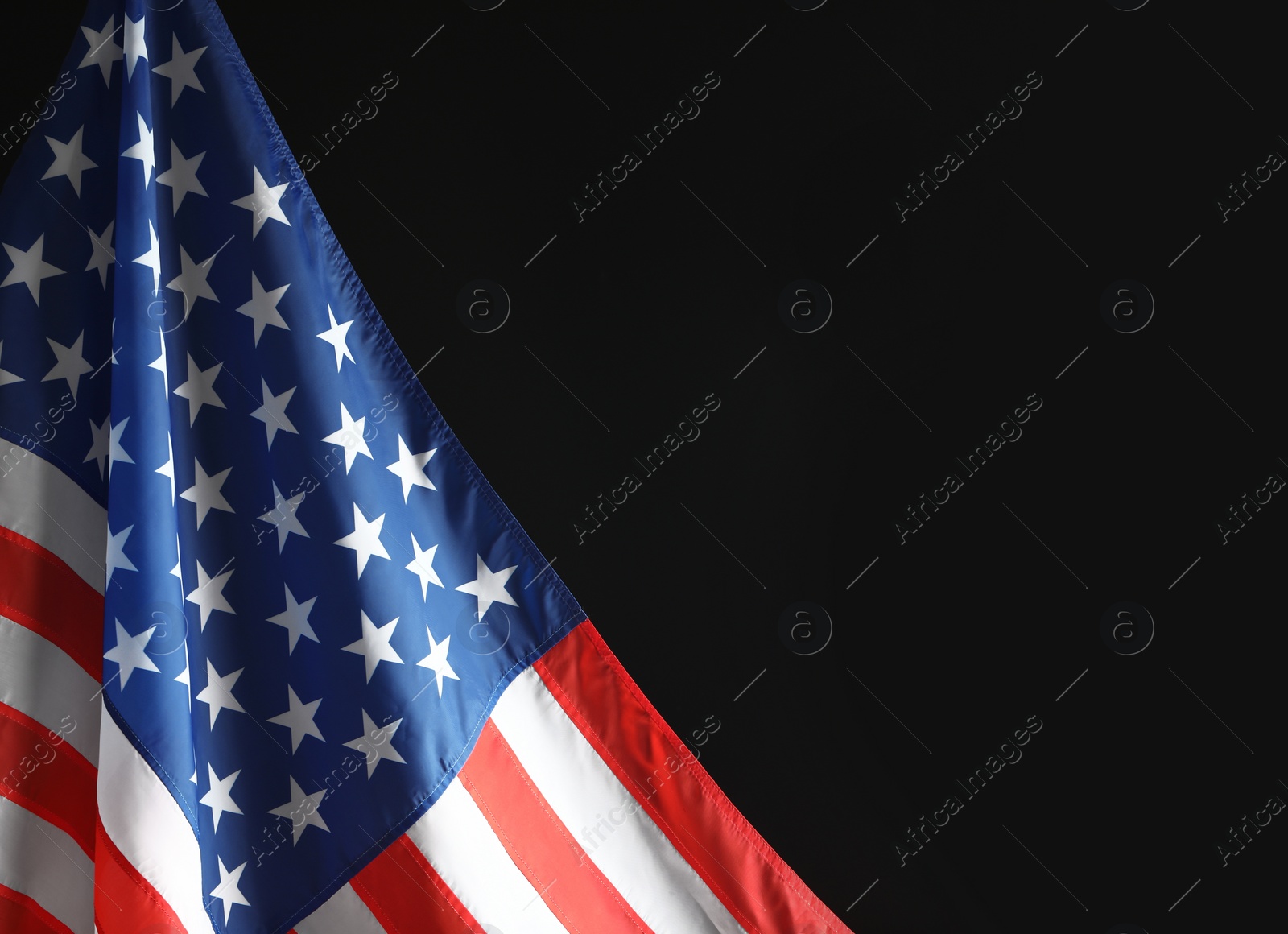 Photo of American flag on black background, closeup with space for text. Memorial Day