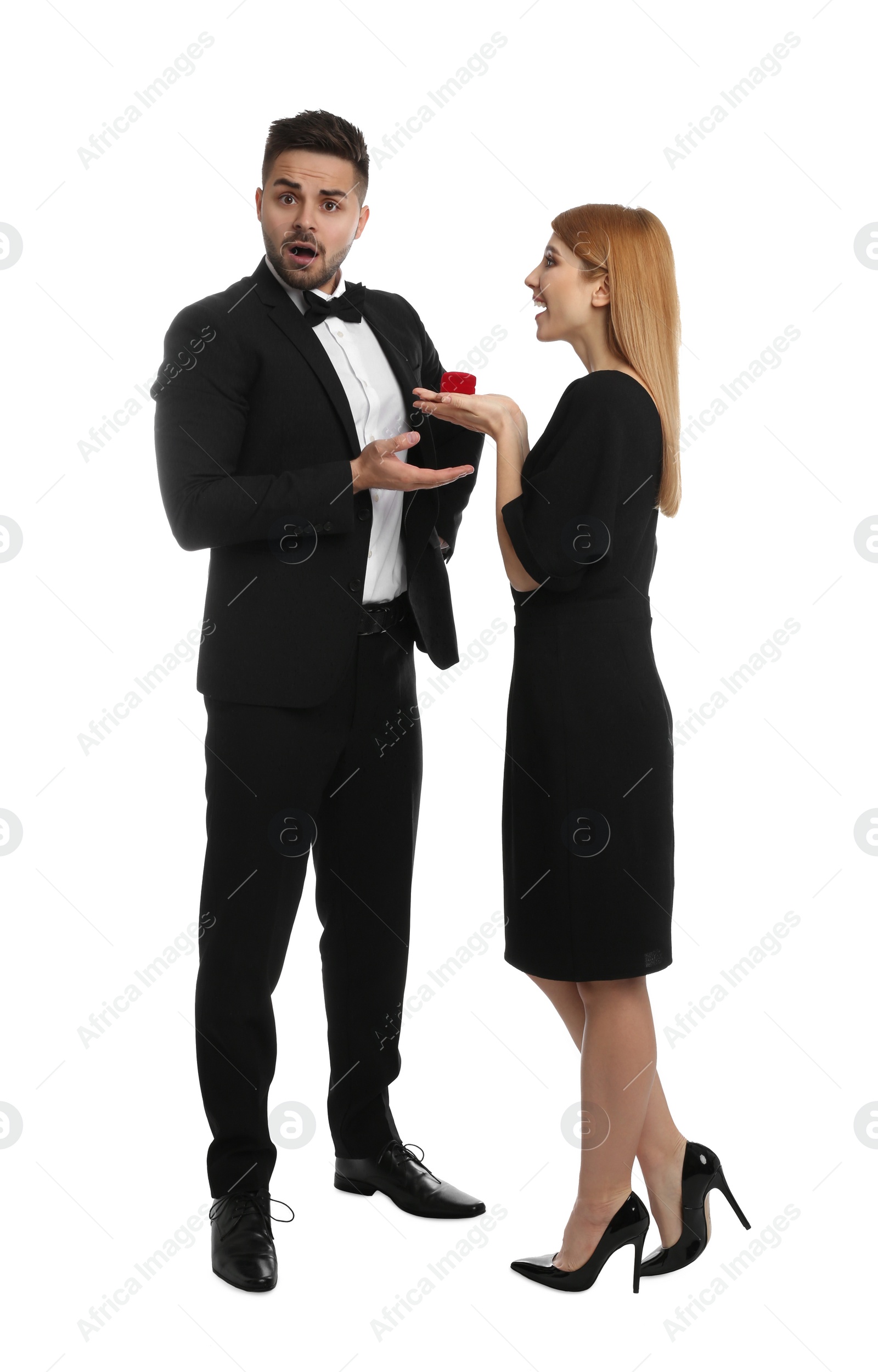 Photo of Young woman with engagement ring making marriage proposal to her boyfriend on white background