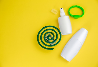 Photo of Set of different insect repellents on yellow background flat lay. Space for text