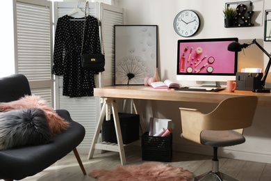 Photo of Modern workplace interior with computer on table