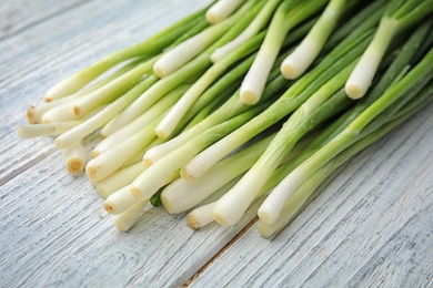 Photo of Fresh green onion on wooden table