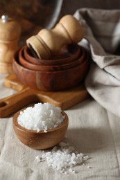 Photo of Organic salt in wooden bowl on table