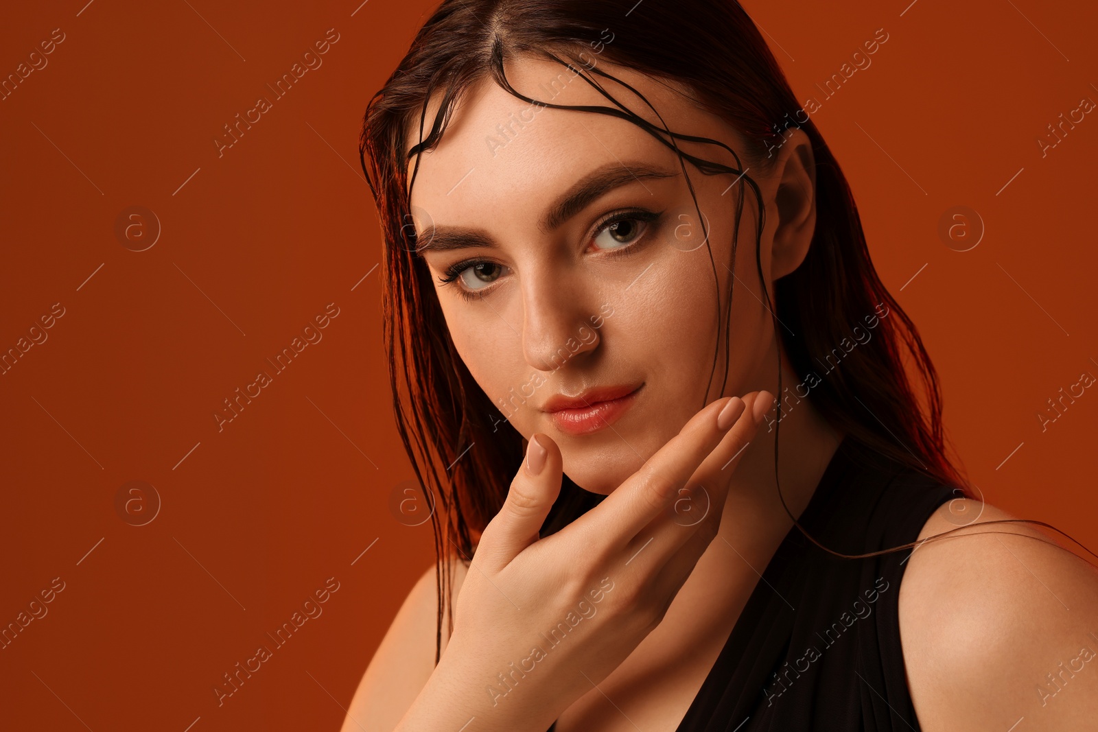 Photo of Portrait of beautiful woman on brown background. Space for text