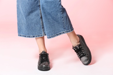 Photo of Woman in stylish shoes on color background, closeup