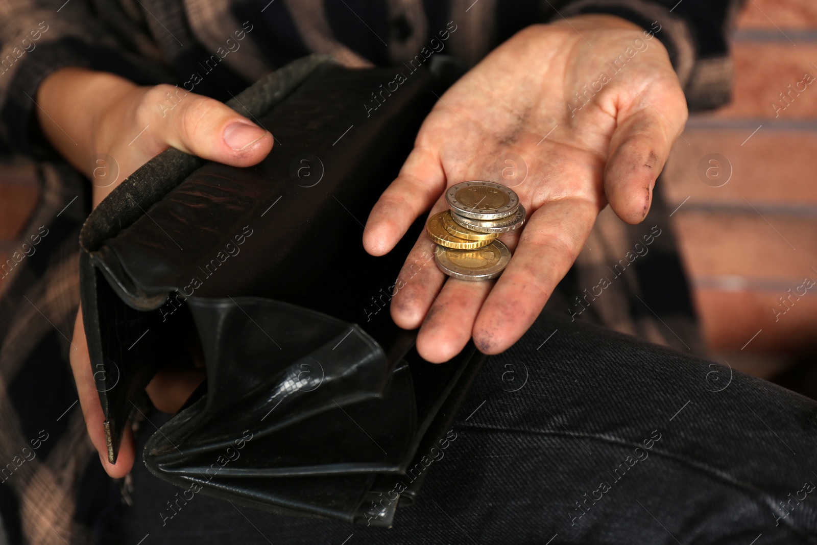 Photo of Poor woman with wallet counting coins, closeup