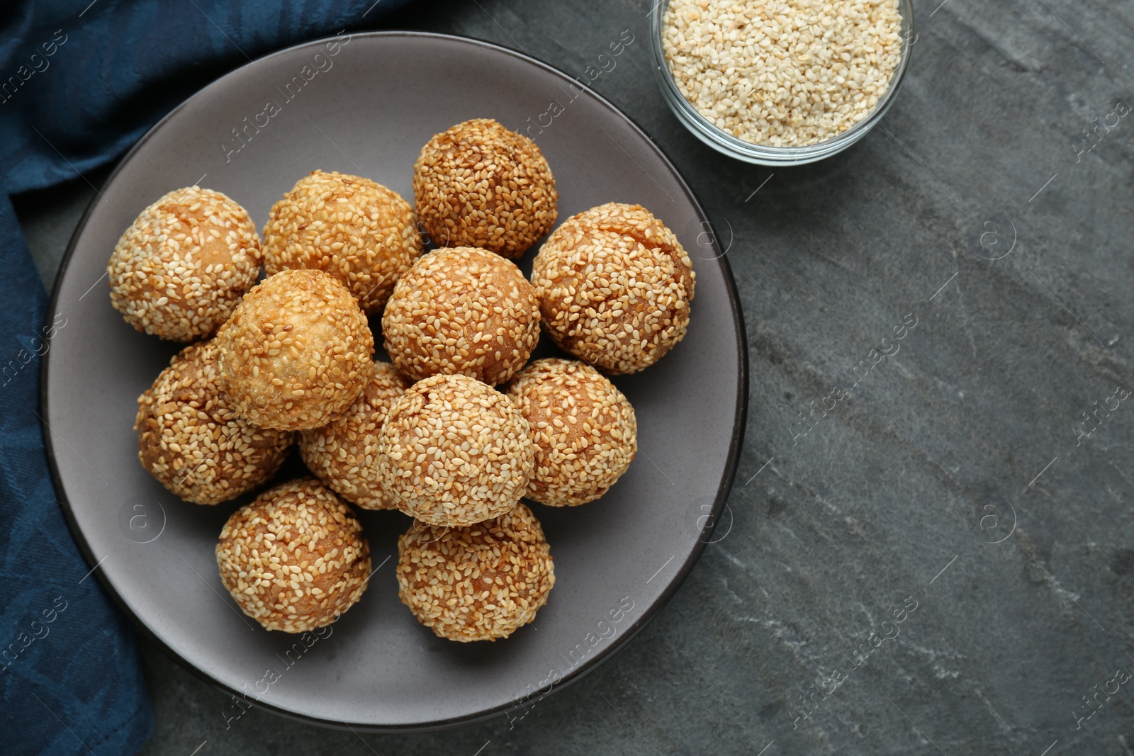 Photo of Delicious sesame balls on grey table, top view. Space for text